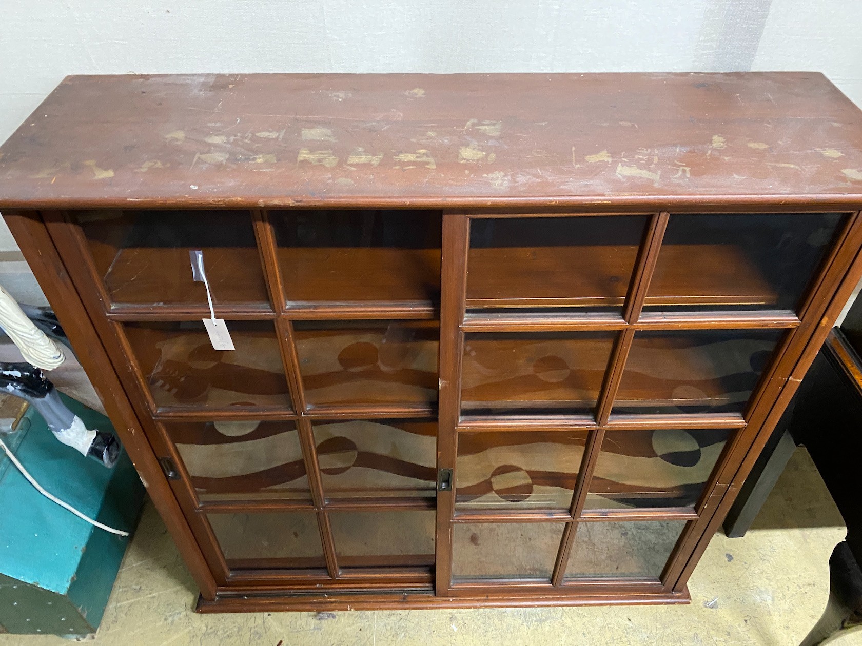 An early 20th century pine sliding door cabinet, width 129cm, depth 38cm, height 125cm